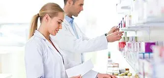 Female and male pharmacists in pharmacy