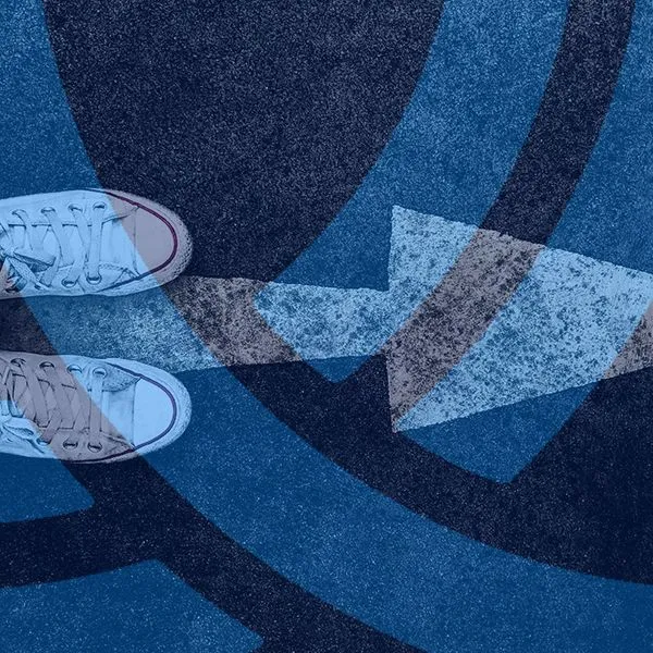 Woman sneaker shoe and Arrow on street with copy space background