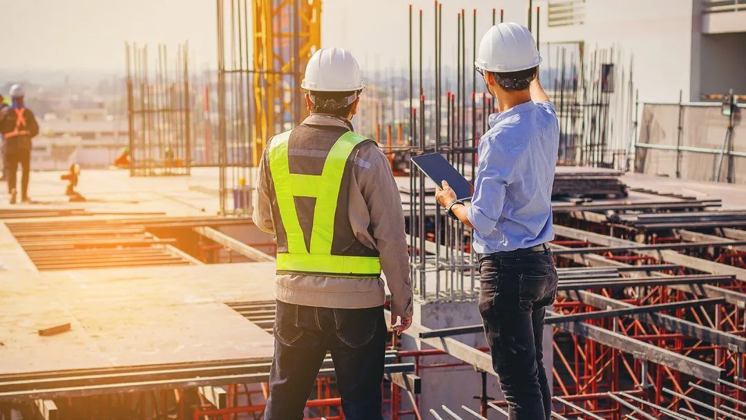 Construction professionals reviewing plans on a building site
