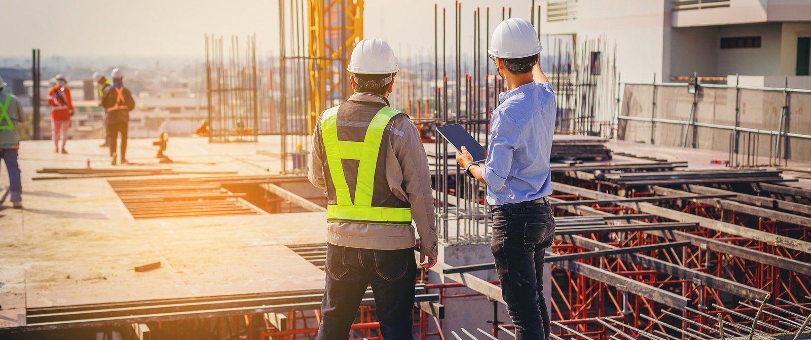 Construction professionals reviewing plans on a building site