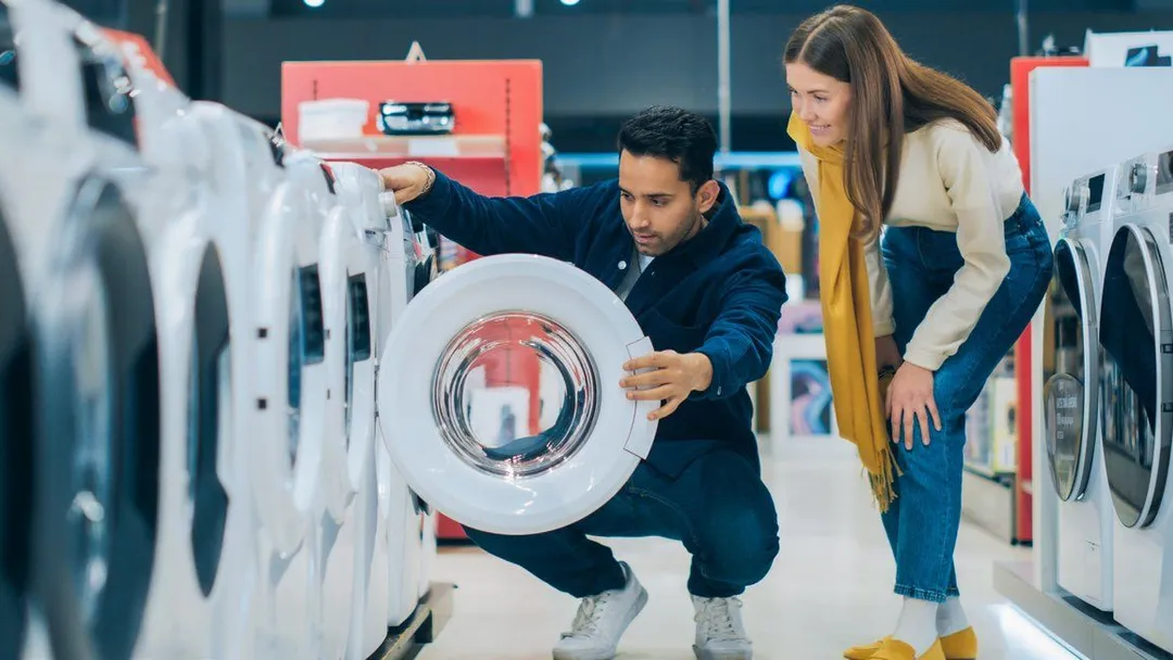 Customers browsing appliances in a Kotsovolos store