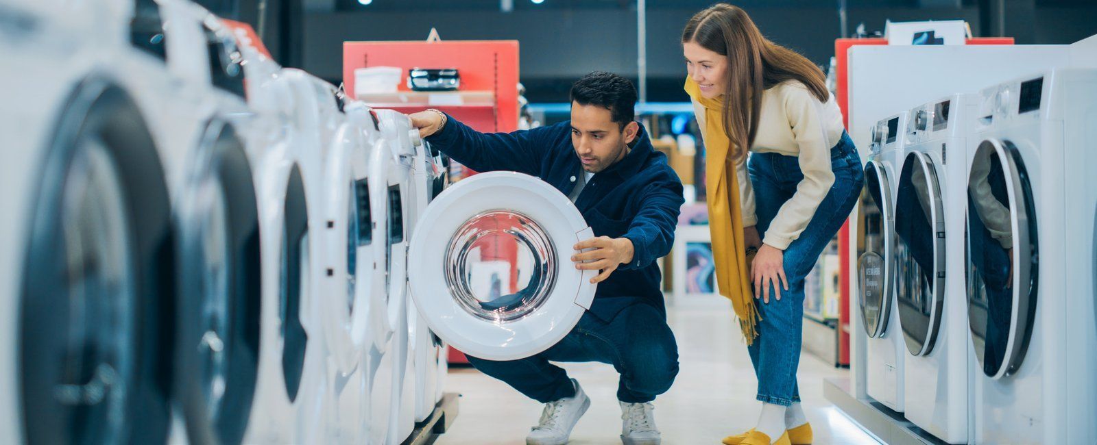 Customers browsing appliances in a Kotsovolos store