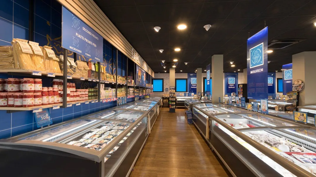 Inside a Sapore di Mare store, with chest freezers and shelved products