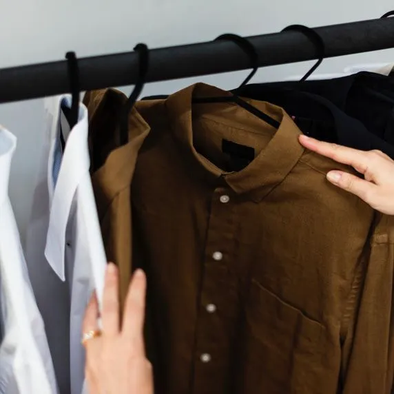 woman-choosing-brown-shirt