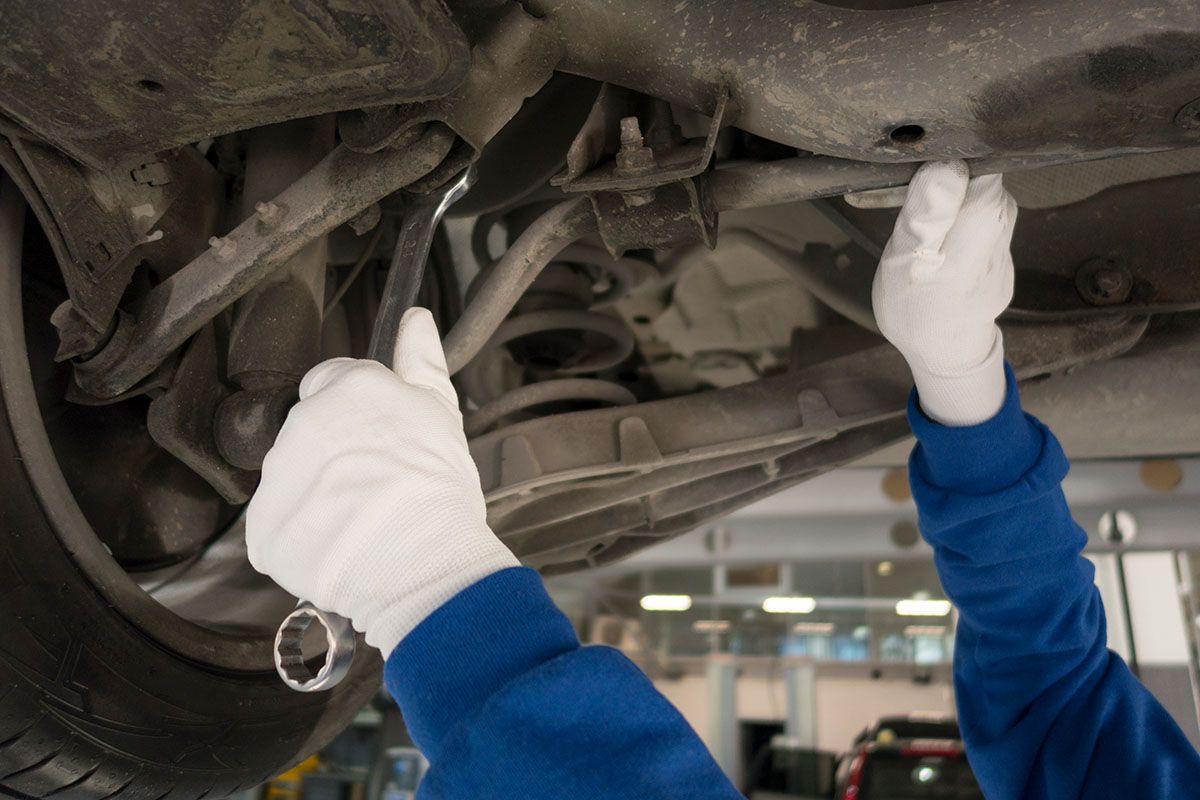Mechanic repairing a vehicle in a service workshop