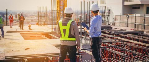 Construction professionals reviewing plans on a building site
