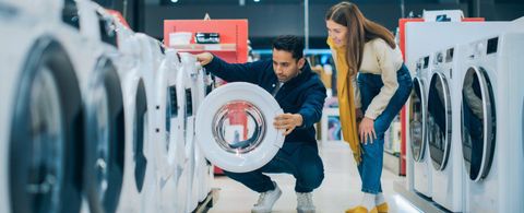 Customers browsing appliances in a Kotsovolos store