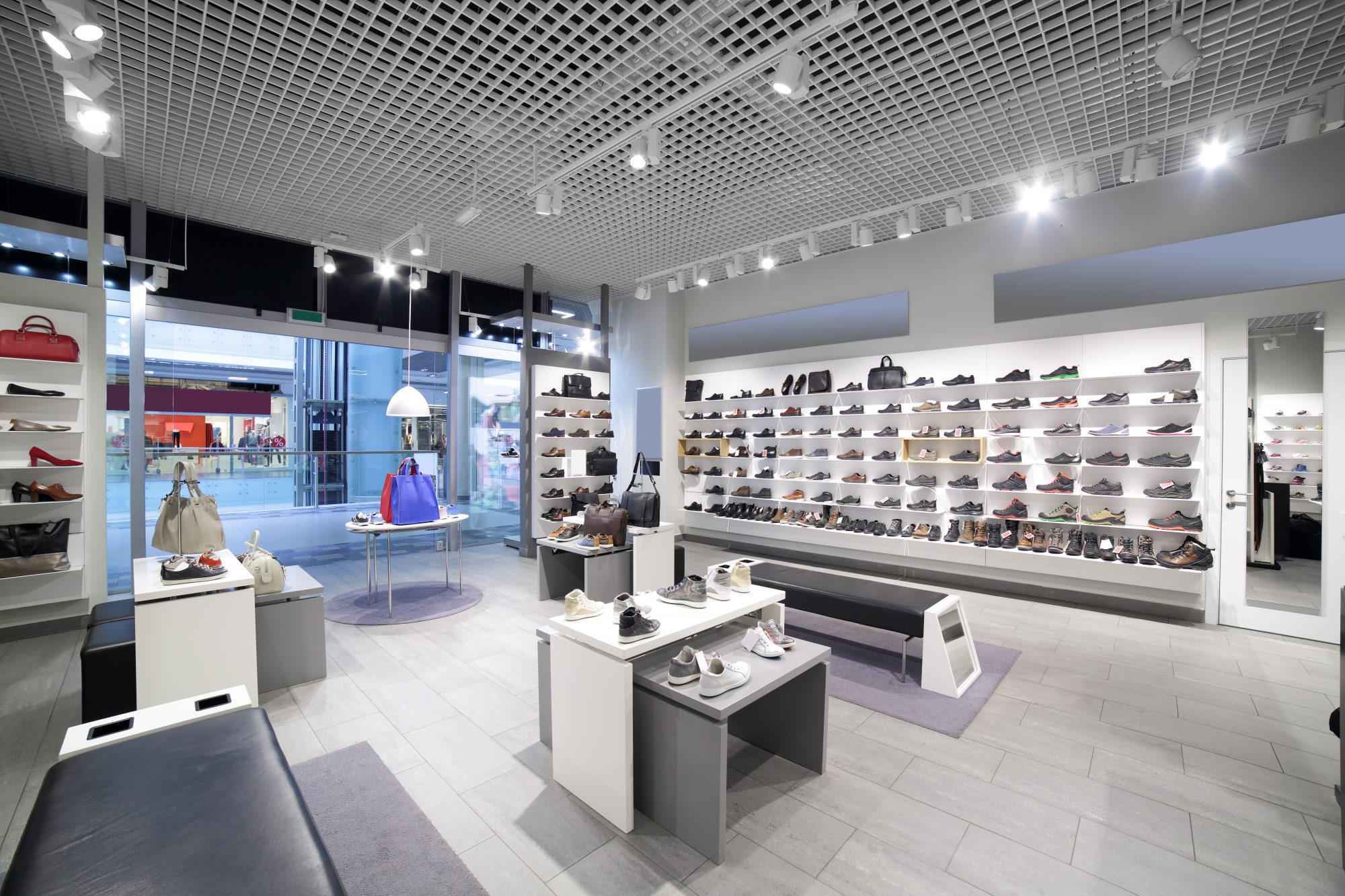 bright and fashionable interior of shoe store in modern mall